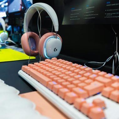 Stylish gaming setup featuring a pink mechanical keyboard and wireless headset